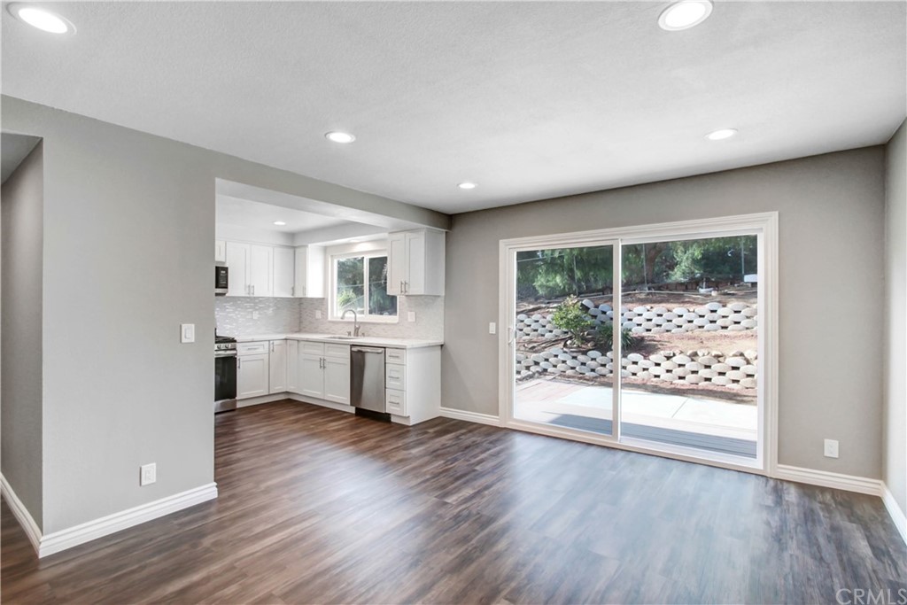 550 Termino Avenue Corona, CA 92879 - Photo 5 of 20 a open kitchen with white cabinets and wooden floor