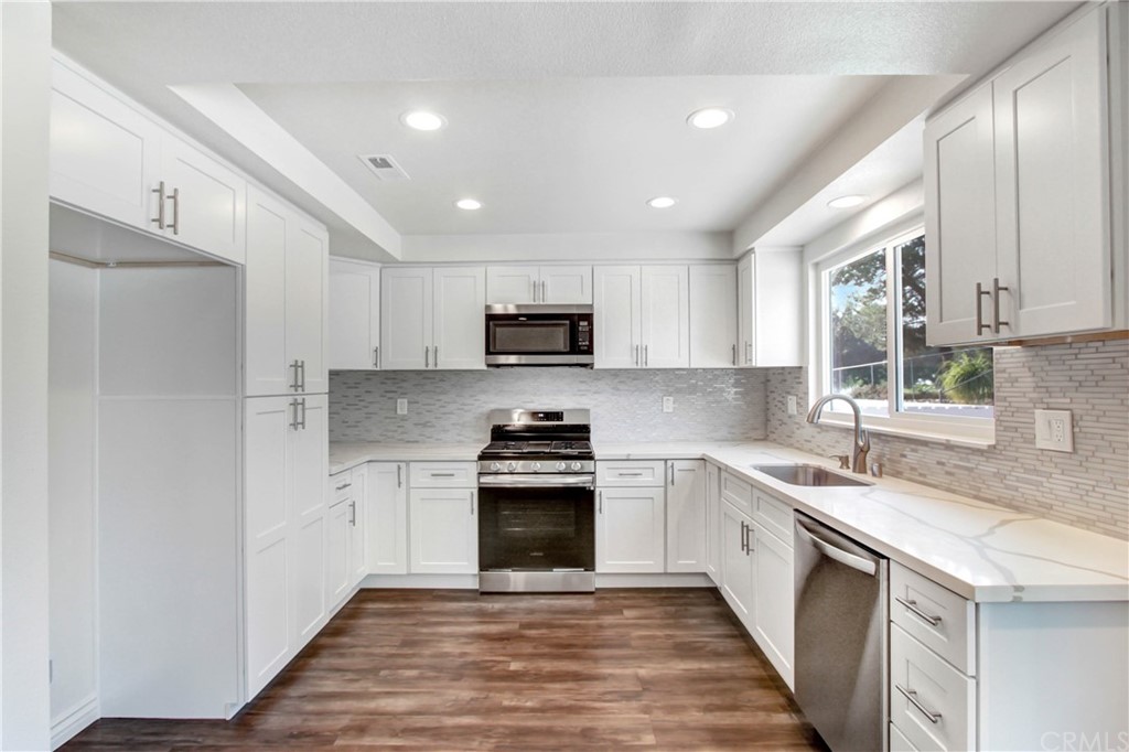 550 Termino Avenue Corona, CA 92879 - Photo 6 of 20 a kitchen with a sink stainless steel appliances and cabinets