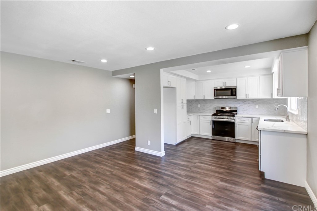 550 Termino Avenue Corona, CA 92879 - Photo 7 of 20 a view of kitchen view wooden floor and stainless steel appliances