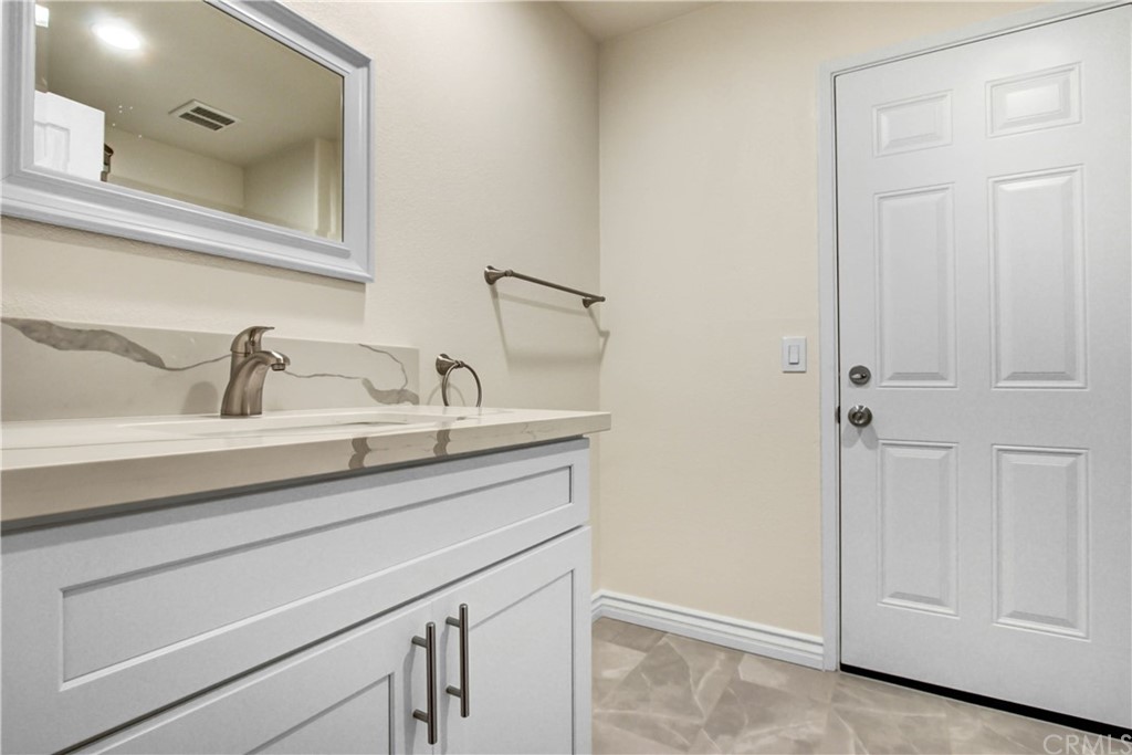 550 Termino Avenue Corona, CA 92879 - Photo 9 of 20 a sink with a mirror