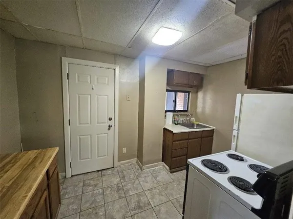 a kitchen that has a sink and a stove in it