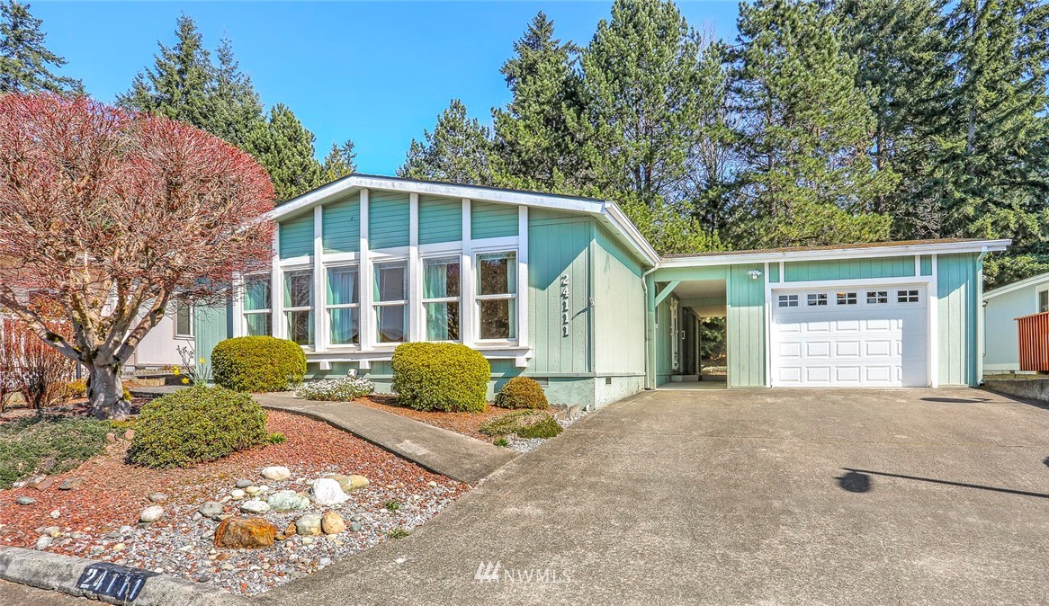 24111 8th Place West Bothell, WA 98021 - Photo 2 of 34 a front view of a house with a yard and garage