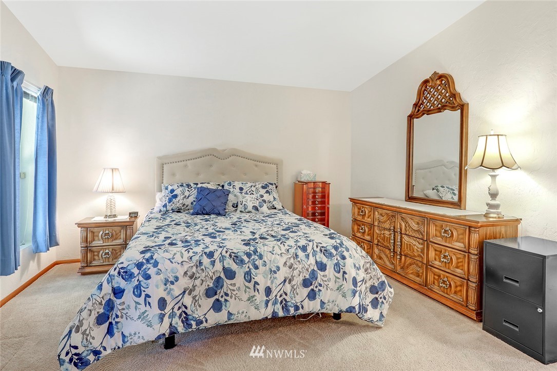 24111 8th Place West Bothell, WA 98021 - Photo 22 of 34 a bedroom with a bed a dresser and next to a window