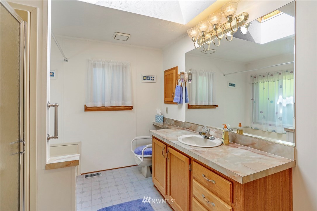 24111 8th Place West Bothell, WA 98021 - Photo 23 of 34 a bathroom with a sink vanity granite and a mirror