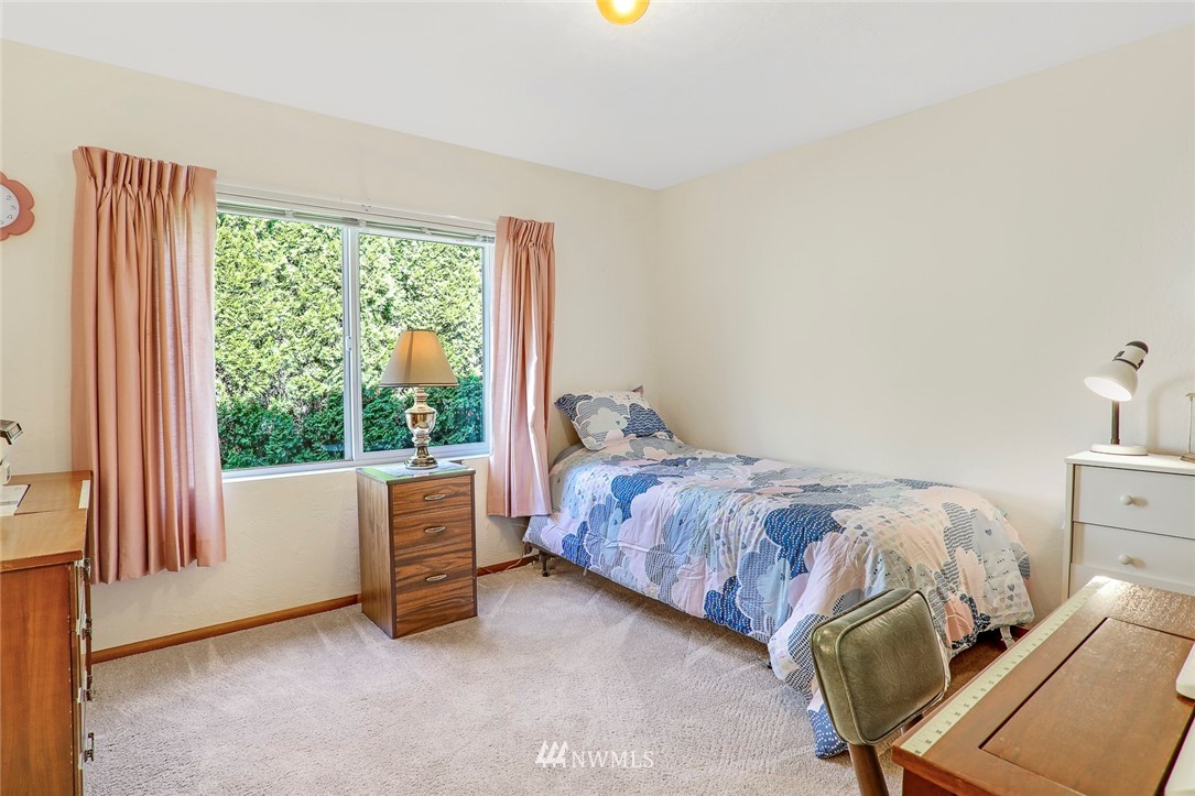 24111 8th Place West Bothell, WA 98021 - Photo 25 of 34 a bedroom with a bed and a chair