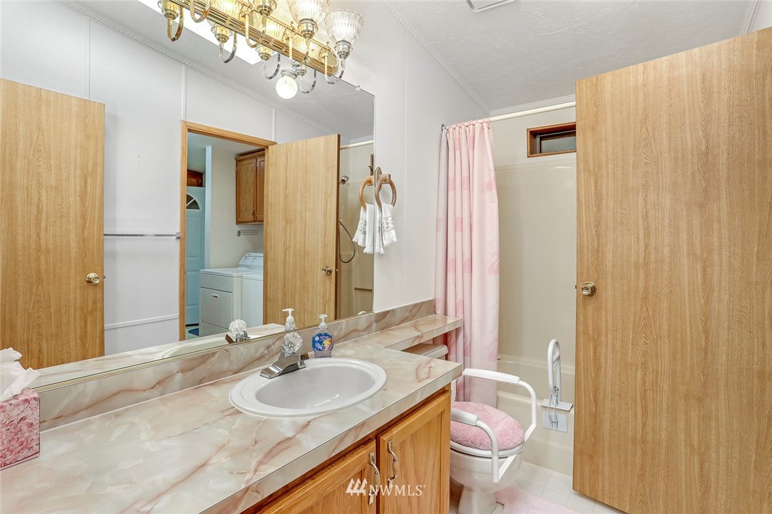 24111 8th Place West Bothell, WA 98021 - Photo 27 of 34 a bathroom with a granite countertop sink and a mirror