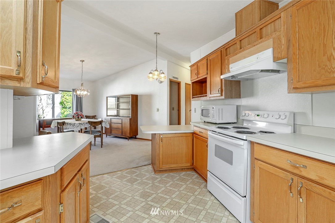 24111 8th Place West Bothell, WA 98021 - Photo 4 of 34 a kitchen with stainless steel appliances granite countertop a sink a stove and a refrigerator