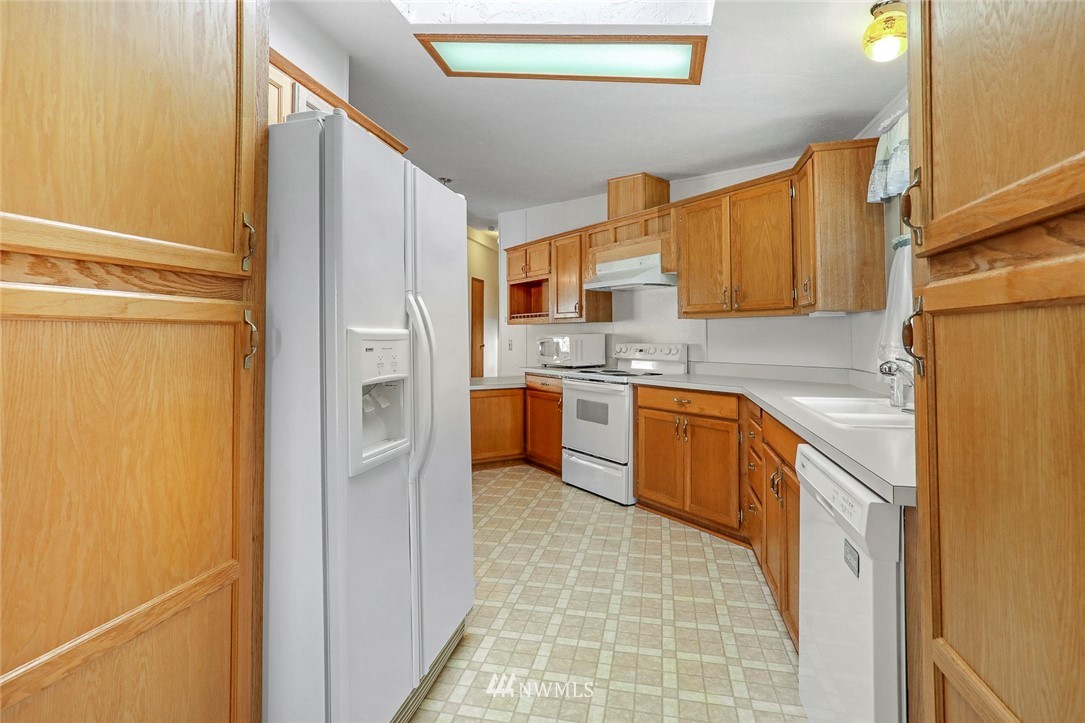 24111 8th Place West Bothell, WA 98021 - Photo 5 of 34 a kitchen with stainless steel appliances granite countertop a refrigerator a stove and a sink