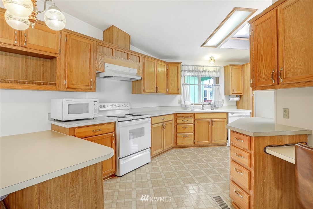 24111 8th Place West Bothell, WA 98021 - Photo 6 of 34 a kitchen with stainless steel appliances granite countertop a sink and cabinets