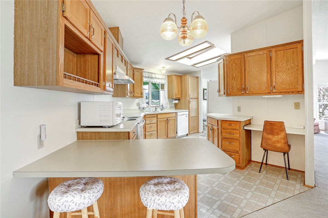 24111 8th Place West Bothell, WA 98021 - Photo 7 of 34 a kitchen with stainless steel appliances granite countertop a granite counter tops and a view of living room