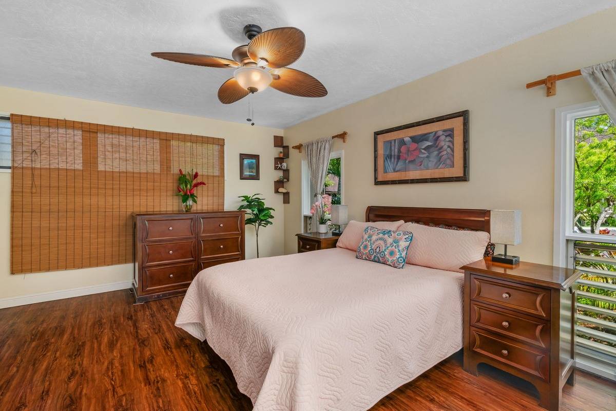 4480 Ka Haku Road, Unit 105 Princeville, HI 96722 - Photo 13 of 25 a bedroom with a bed and wooden floor
