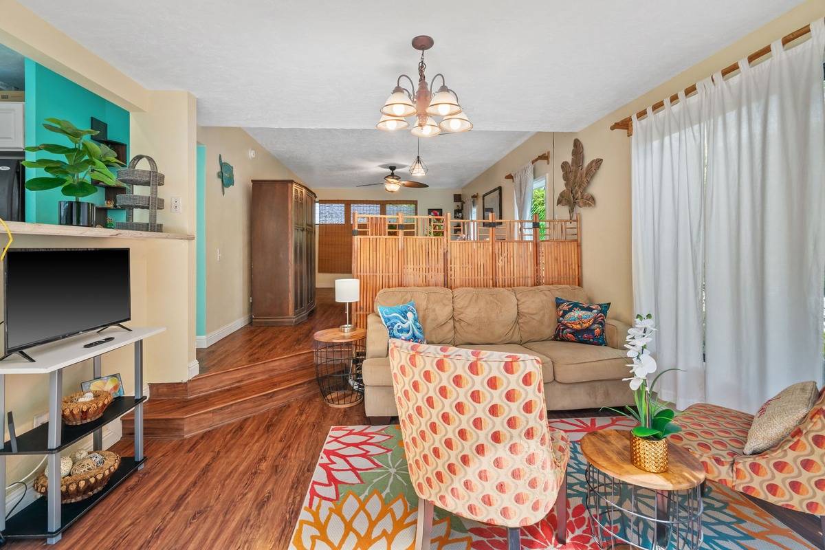 4480 Ka Haku Road, Unit 105 Princeville, HI 96722 - Photo 20 of 25 a living room with furniture and a flat screen tv