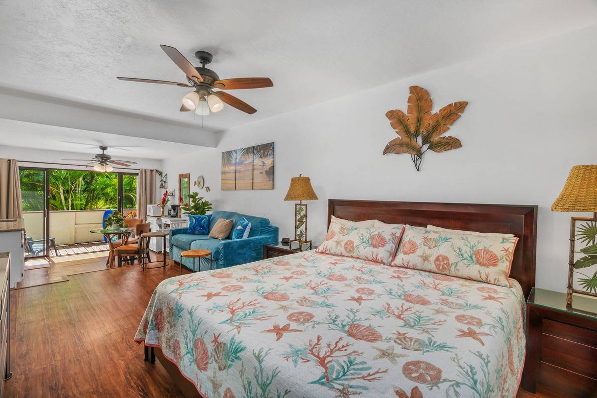 4480 Ka Haku Road, Unit 105 Princeville, HI 96722 - Photo 2 of 25 a bedroom with furniture and a large window