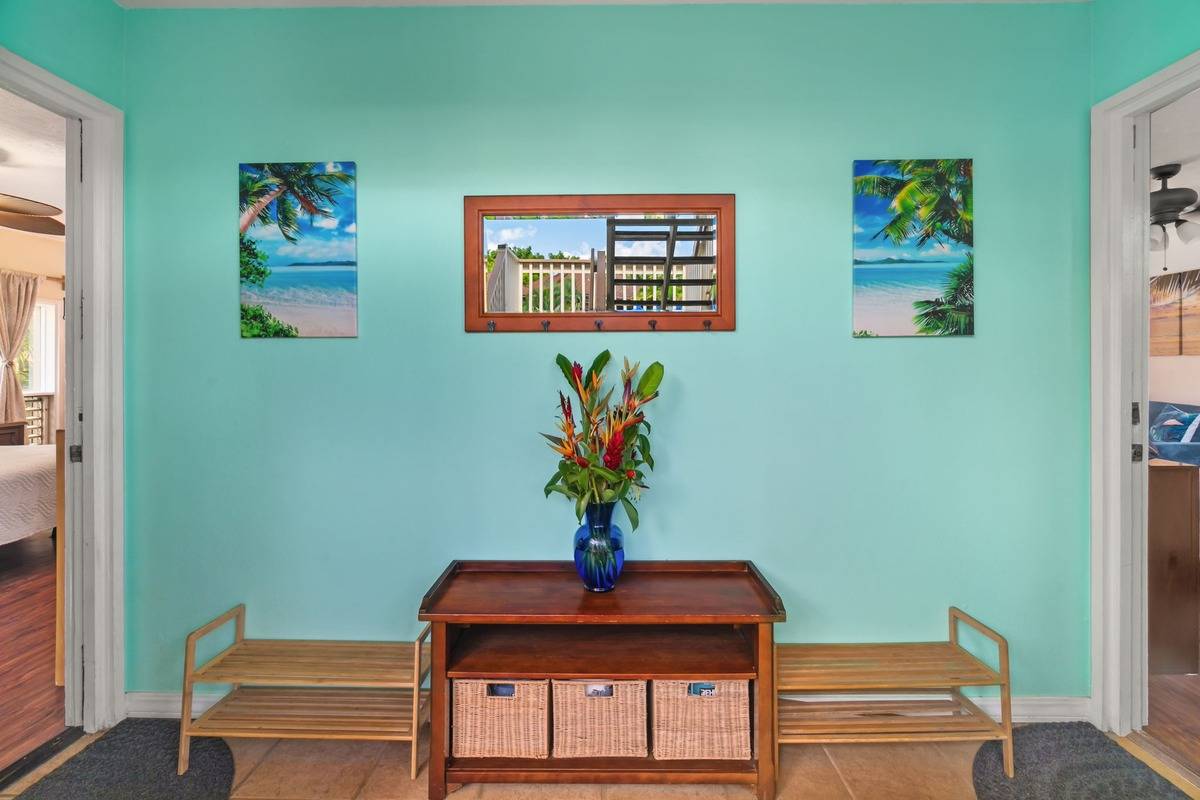 4480 Ka Haku Road, Unit 105 Princeville, HI 96722 - Photo 21 of 25 a room with painting on the wall and a potted plant