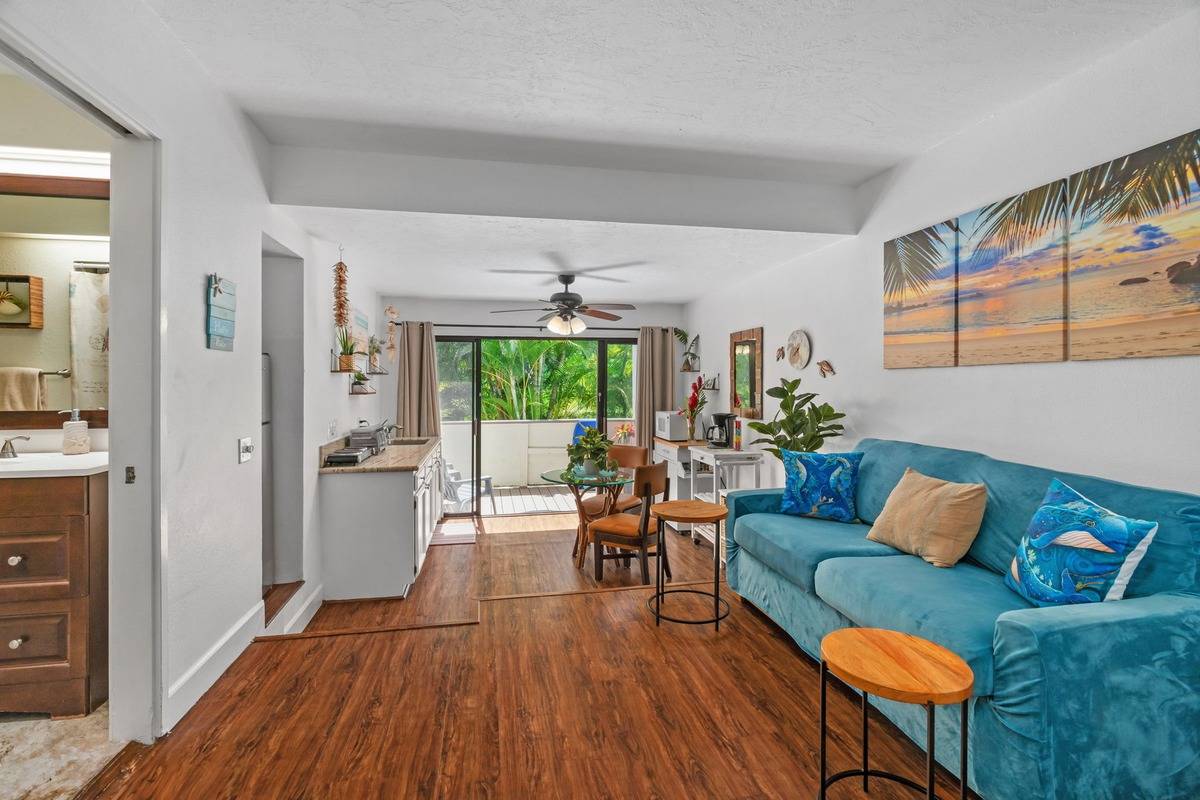 4480 Ka Haku Road, Unit 105 Princeville, HI 96722 - Photo 3 of 25 a living room with furniture and a wooden floor
