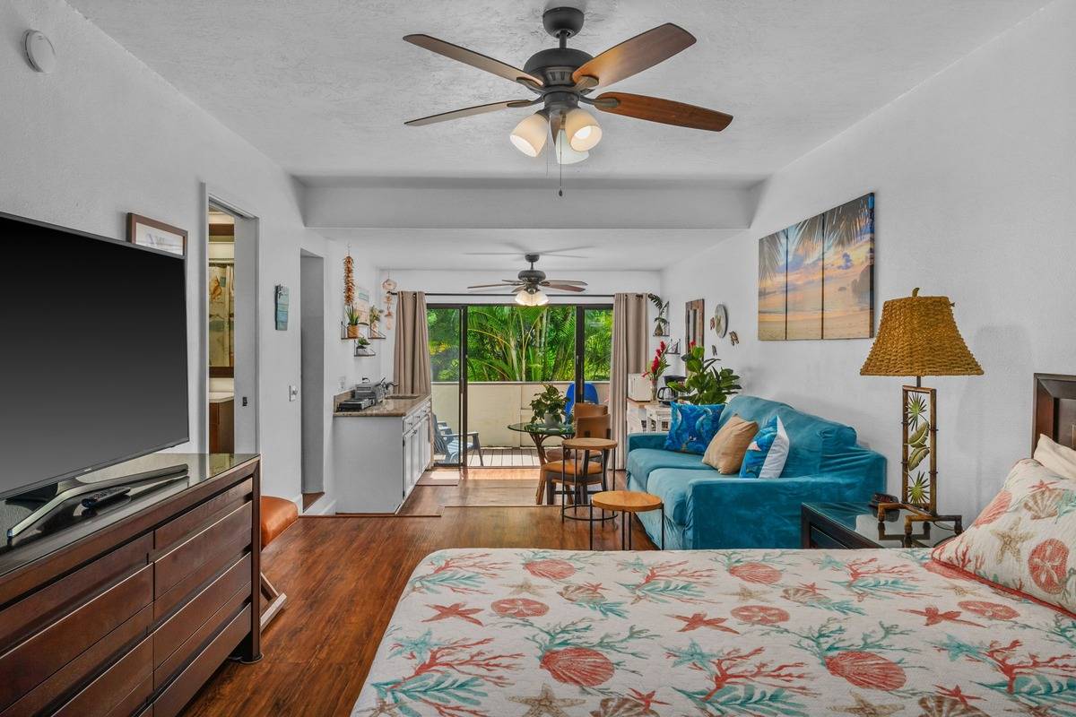 4480 Ka Haku Road, Unit 105 Princeville, HI 96722 - Photo 4 of 25 a living room with furniture and a flat screen tv