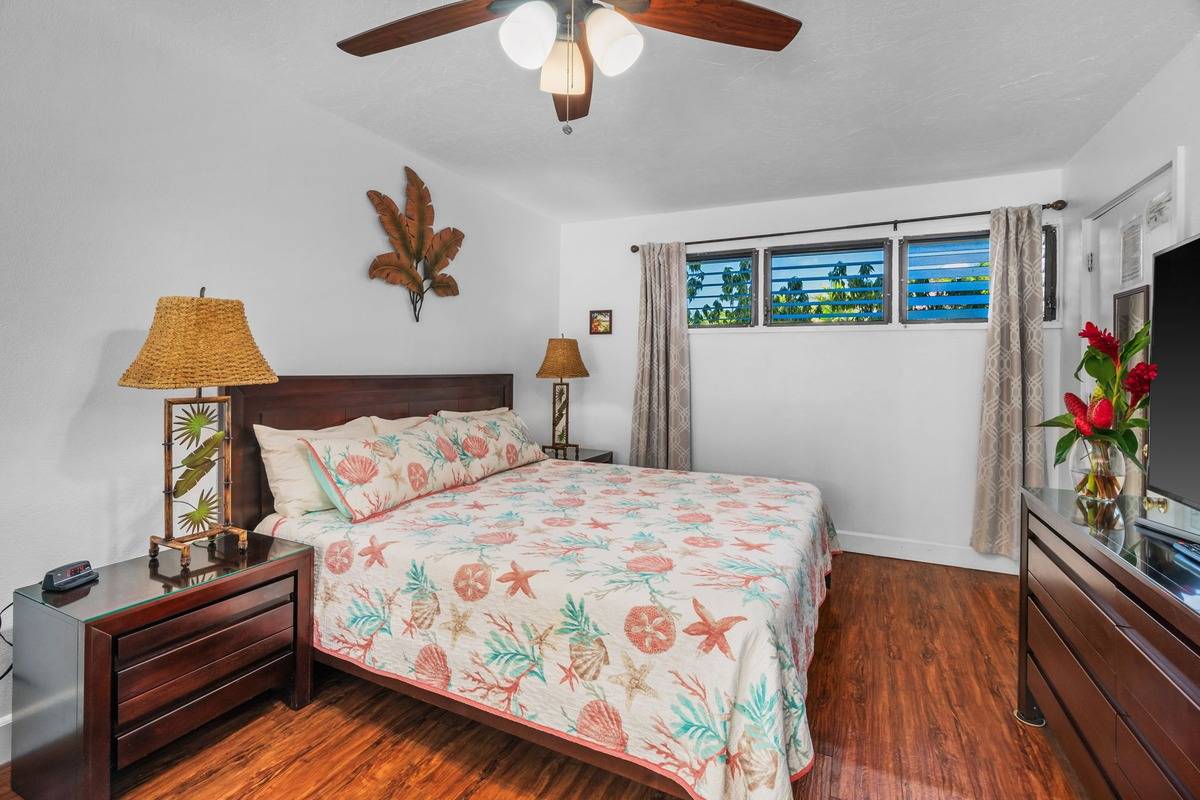 4480 Ka Haku Road, Unit 105 Princeville, HI 96722 - Photo 5 of 25 a bedroom with a bed and a flat tv screen on dresser