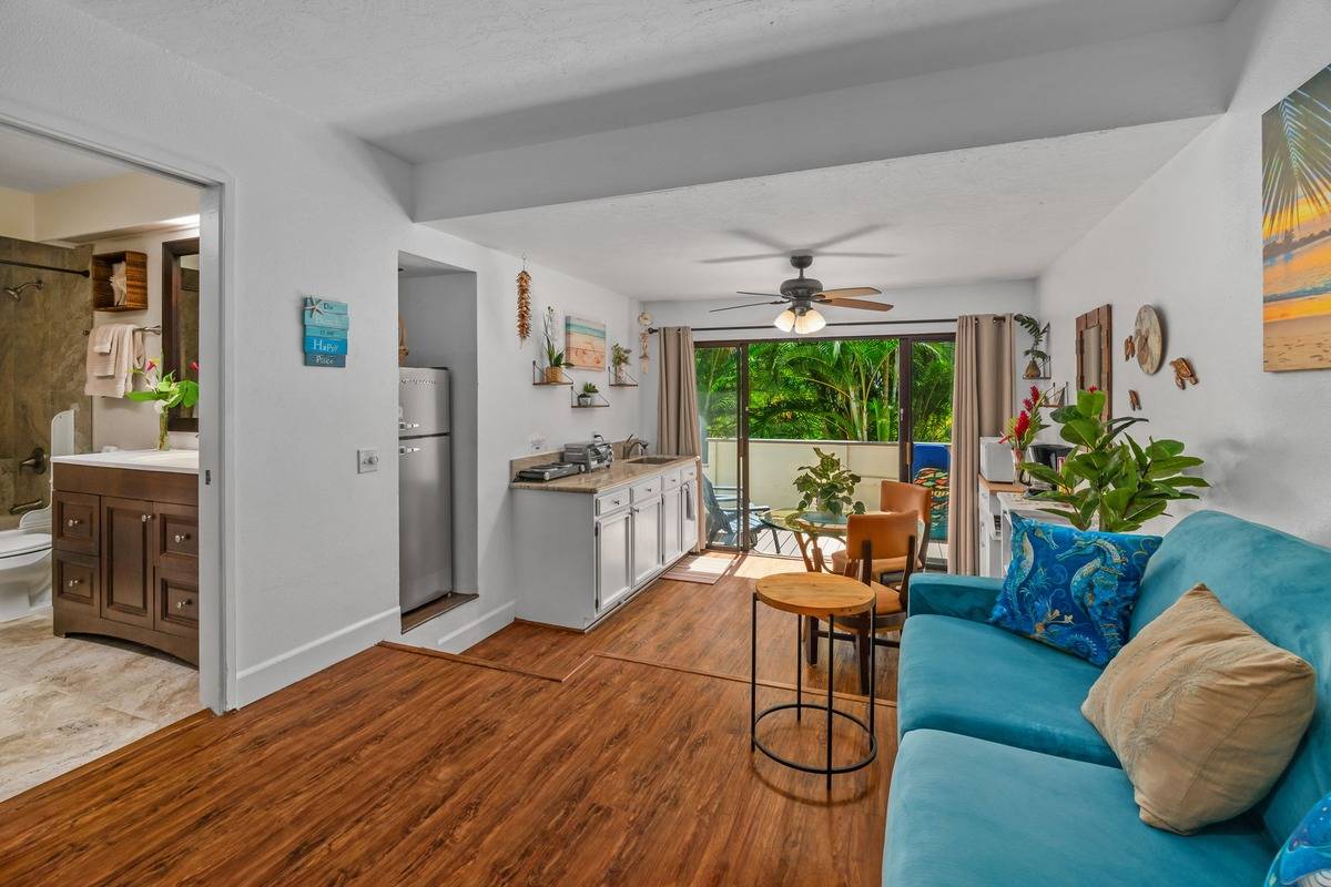 4480 Ka Haku Road, Unit 105 Princeville, HI 96722 - Photo 6 of 25 a living room with furniture and a large window