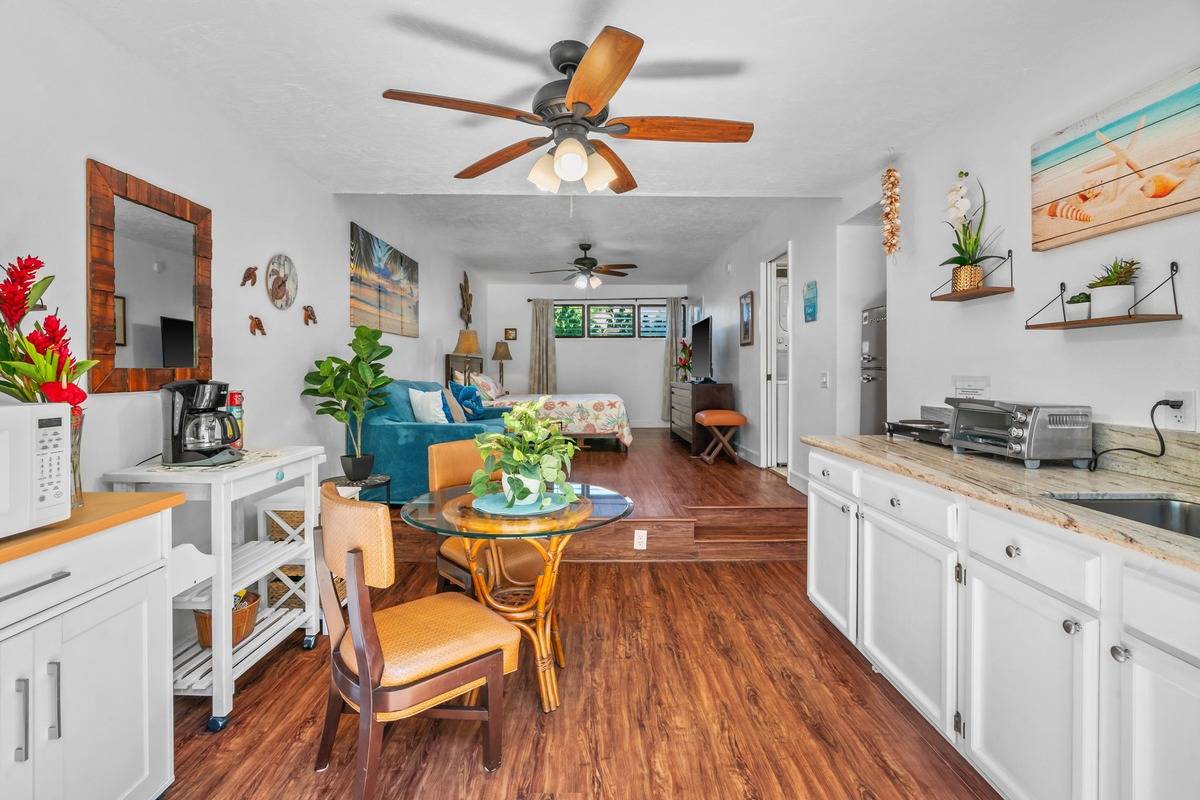 4480 Ka Haku Road, Unit 105 Princeville, HI 96722 - Photo 9 of 25 a view of a dining room with furniture and wooden floor