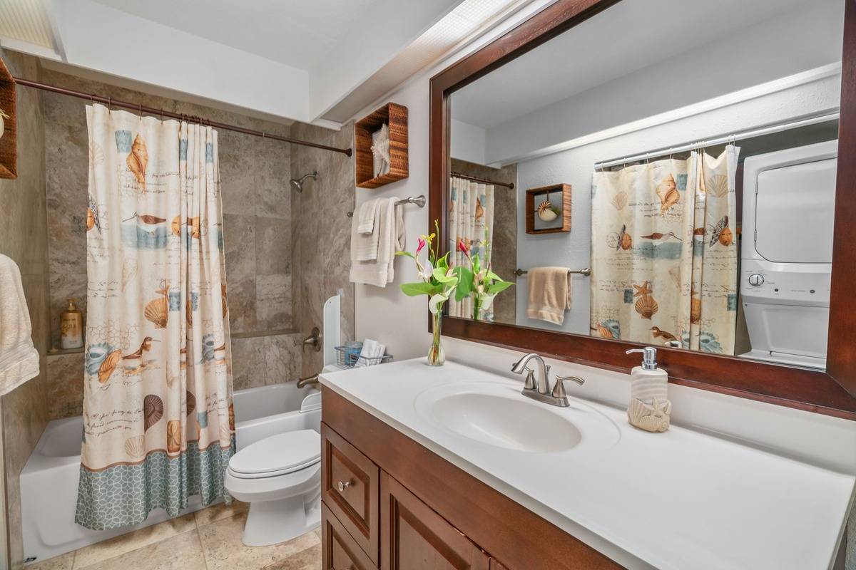 4480 Ka Haku Road, Unit 105 Princeville, HI 96722 - Photo 10 of 25 a bathroom with a granite countertop sink toilet and shower
