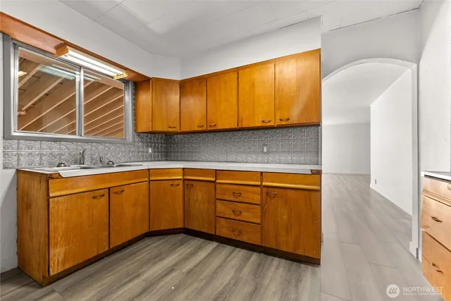 a kitchen with granite countertop wooden cabinets a sink and dishwasher