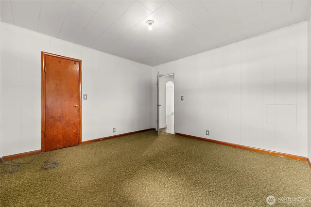 a view of a room with wooden floor and window