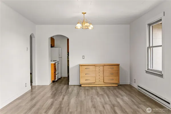 an empty room with windows and cabinet