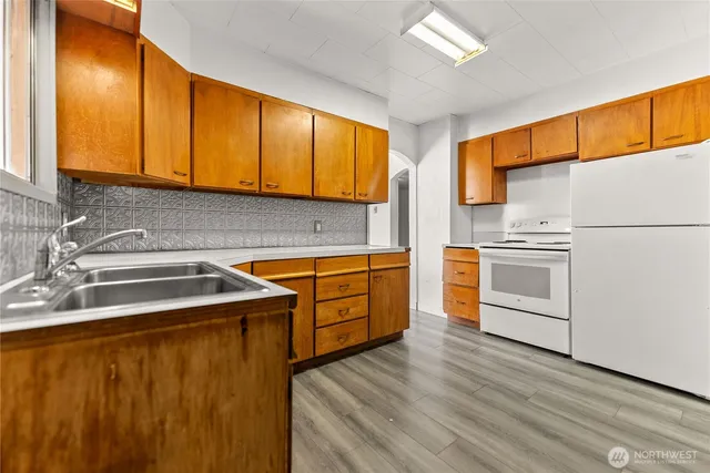 a kitchen with a refrigerator sink and cabinets