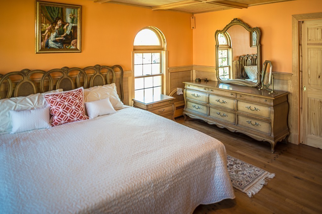 42 Hereford Road Marblehead, MA 01945 - Photo 8 of 19 a bedroom with a bed a dresser next to a window