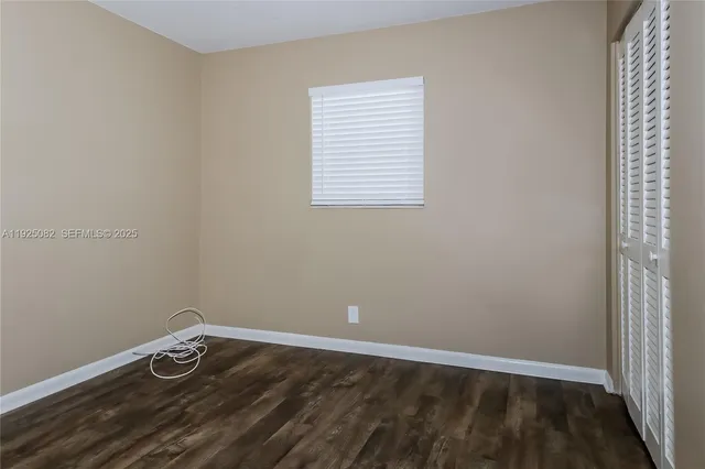 a room with a window and wooden floor