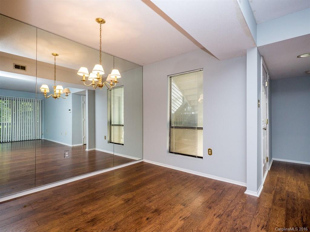 4918 Sardis Road, Unit A Charlotte, NC 28270 - Photo 8 of 19 a view of an empty room with wooden floor and a window