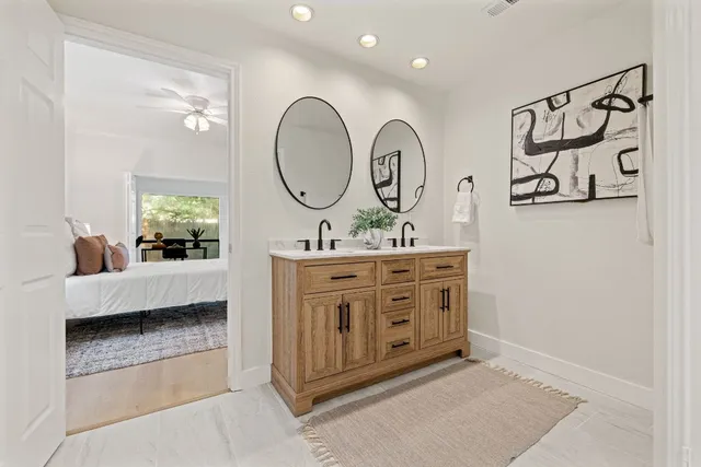 a spacious bathroom with a double vanity sink and a mirror