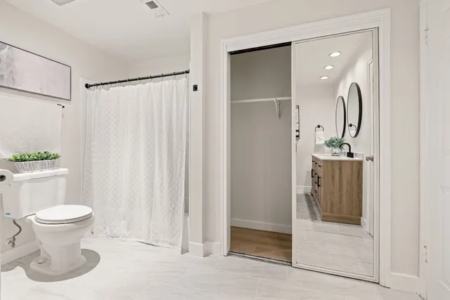 a bathroom with a toilet sink and shower