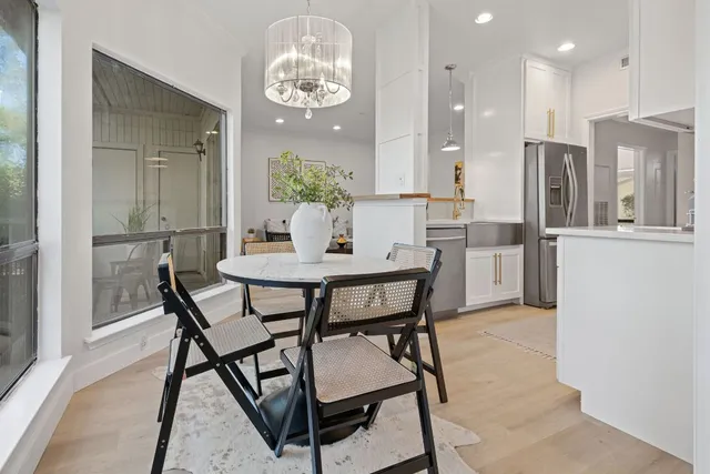 a view of a dining room with furniture and chandelier