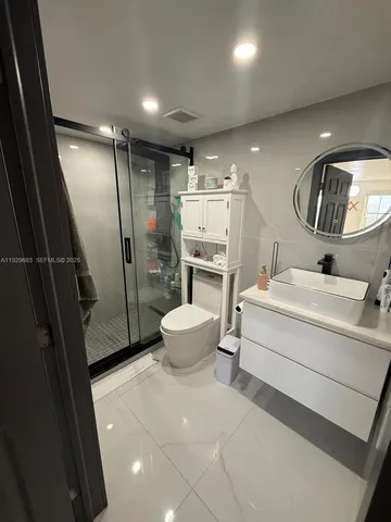 a bathroom with a sink toilet and shower