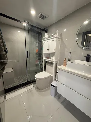 a bathroom with a toilet sink and shower