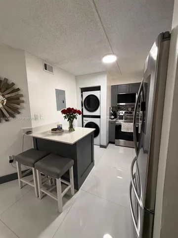 a kitchen with kitchen island a sink stainless steel appliances and cabinets