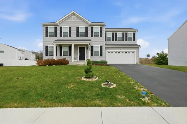 a front view of a house with garden