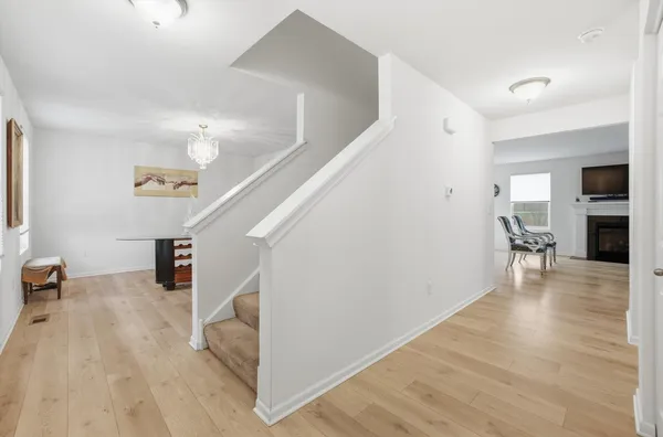 a view of a livingroom with wooden floor and stairs