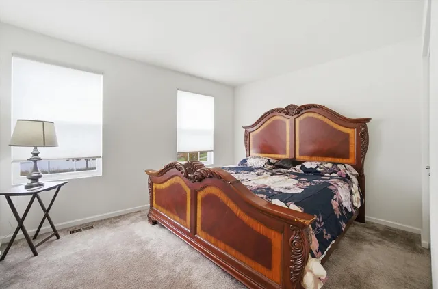 a bedroom with a bed and a lamp