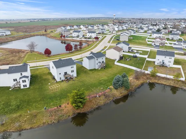 a view of a city with lawn chairs and large trees