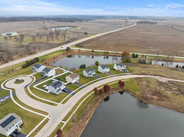 an aerial view of residential houses with outdoor space and parking