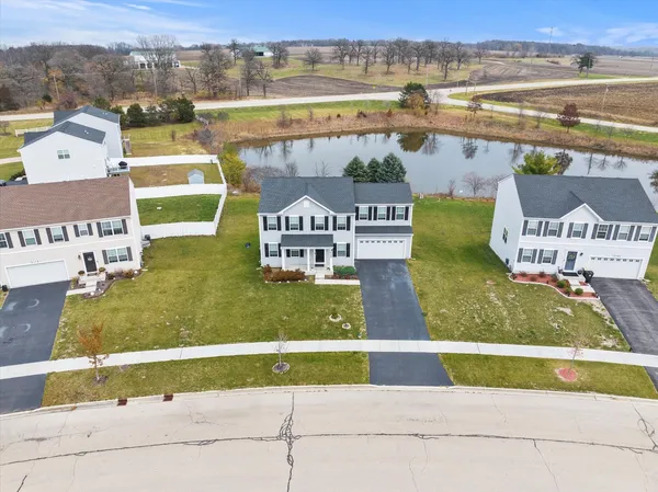 an aerial view of residential houses with outdoor space and parking