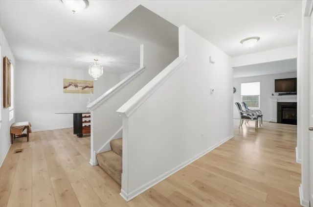 a view of a livingroom with wooden floor and stairs