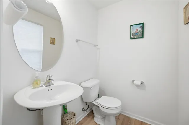 a bathroom with a sink toilet and a mirror
