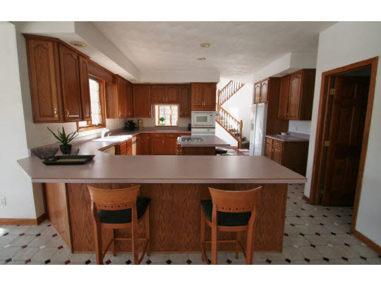 8505 McCurry Road Roscoe, IL 61073 - Photo 4 of 11 a kitchen with a table chairs and refrigerator