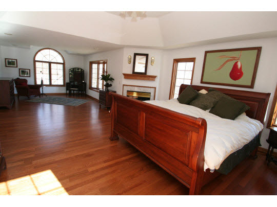 8505 McCurry Road Roscoe, IL 61073 - Photo 6 of 11 a bedroom with furniture and wooden floor