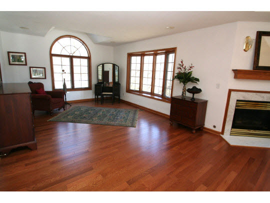 8505 McCurry Road Roscoe, IL 61073 - Photo 8 of 11 a view of an empty room with window wooden floor and a fire place