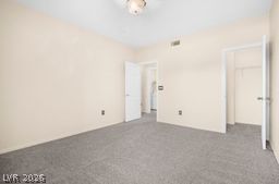 7701 West Robindale Road, Unit 277 Las Vegas, NV 89113 - Photo 20 of 33 The tranquil room features plush carpet flooring and a ceiling light fixture.