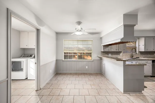 a kitchen with a stove a sink and a refrigerator